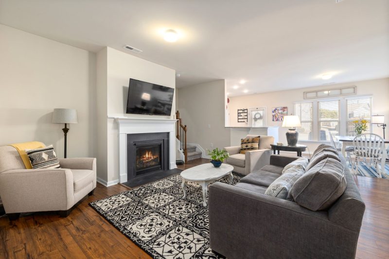 Spacious living room featuring a fireplace TV and comfortabl 1790701286