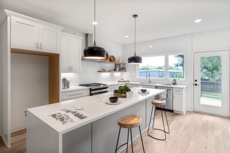 Home 9 Bright modern kitchen with white cabinetry wooden stools and 1792515725